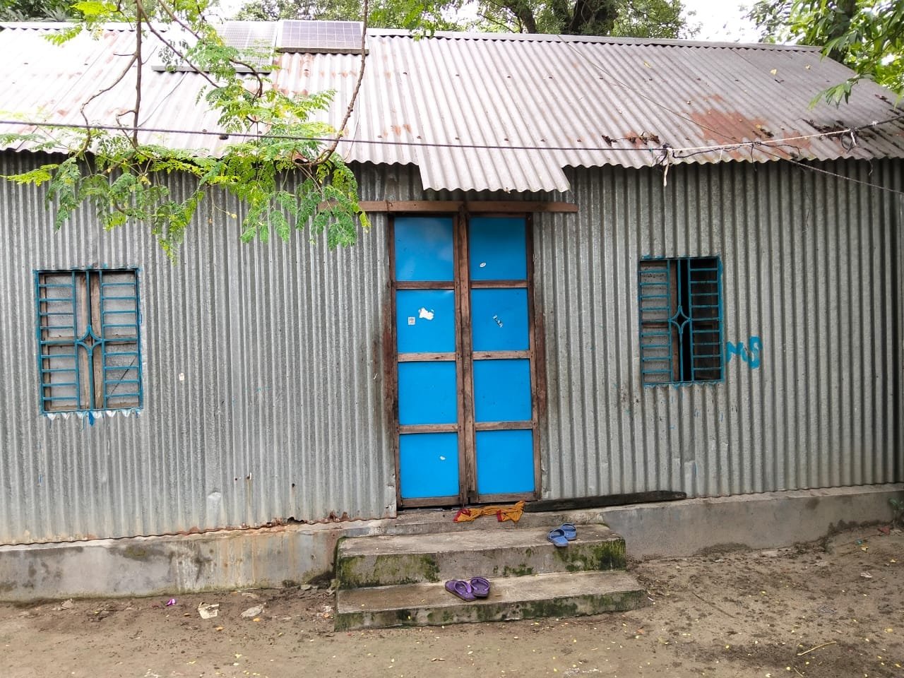 Tin house, blue door.